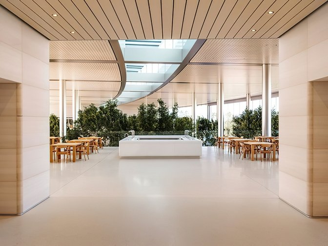 Stone and timber interior opening onto trees, Apple Park, Cupertino, California