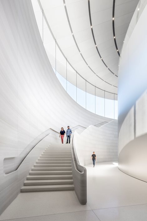 Sculpted white staircase beneath a curved skylight, Apple Park, Cupertino, California