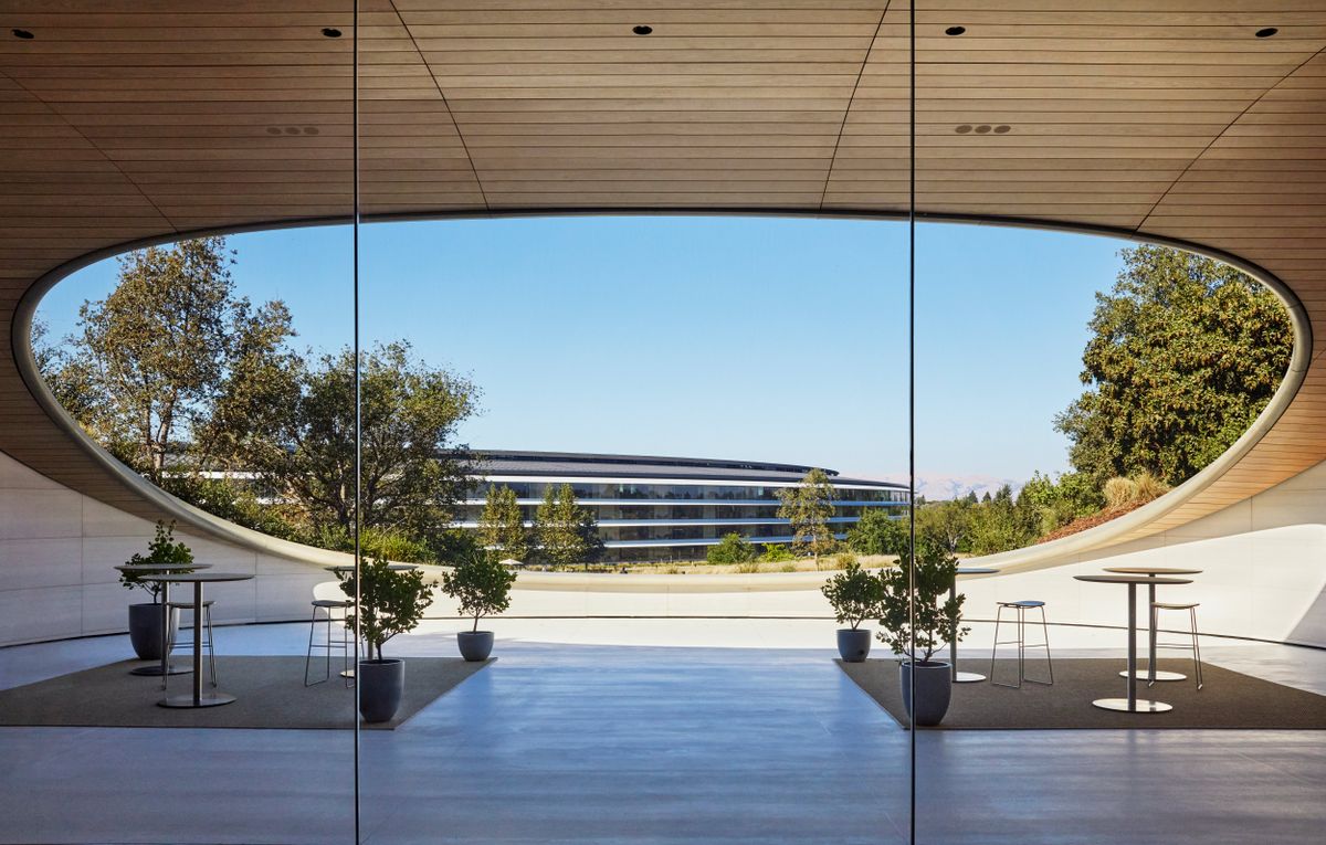 Timber-lined pavilion framing a view of the ring building, Apple Park, Cupertino, California