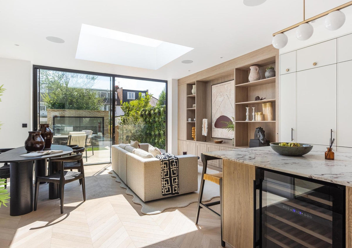 Open-plan kitchen and living space with roof light and full-height glazing to the garden, West Hampstead home, London