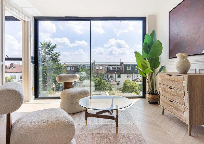 Loft suite with frameless full-height glazing and open rooftop views, West Hampstead home, London